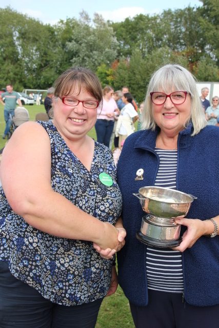 Julie presents the cup to Vicky